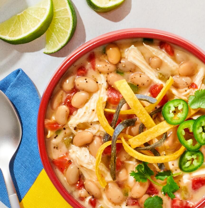 Instant Pot or slow cooker white chicken chili with white beans, tortilla chips and jalapeños.