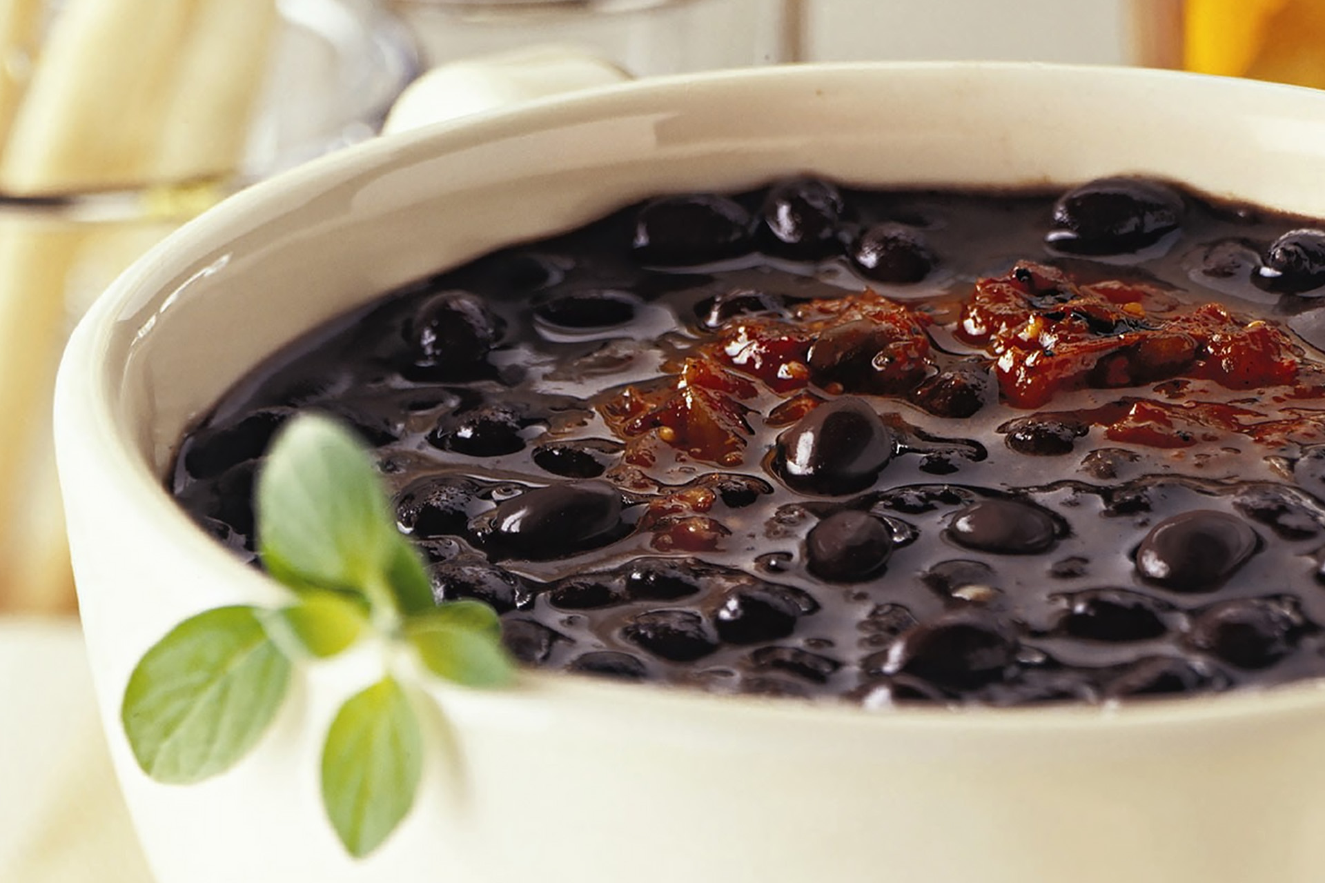 Close up of Cajun black bean soup in a white bowl