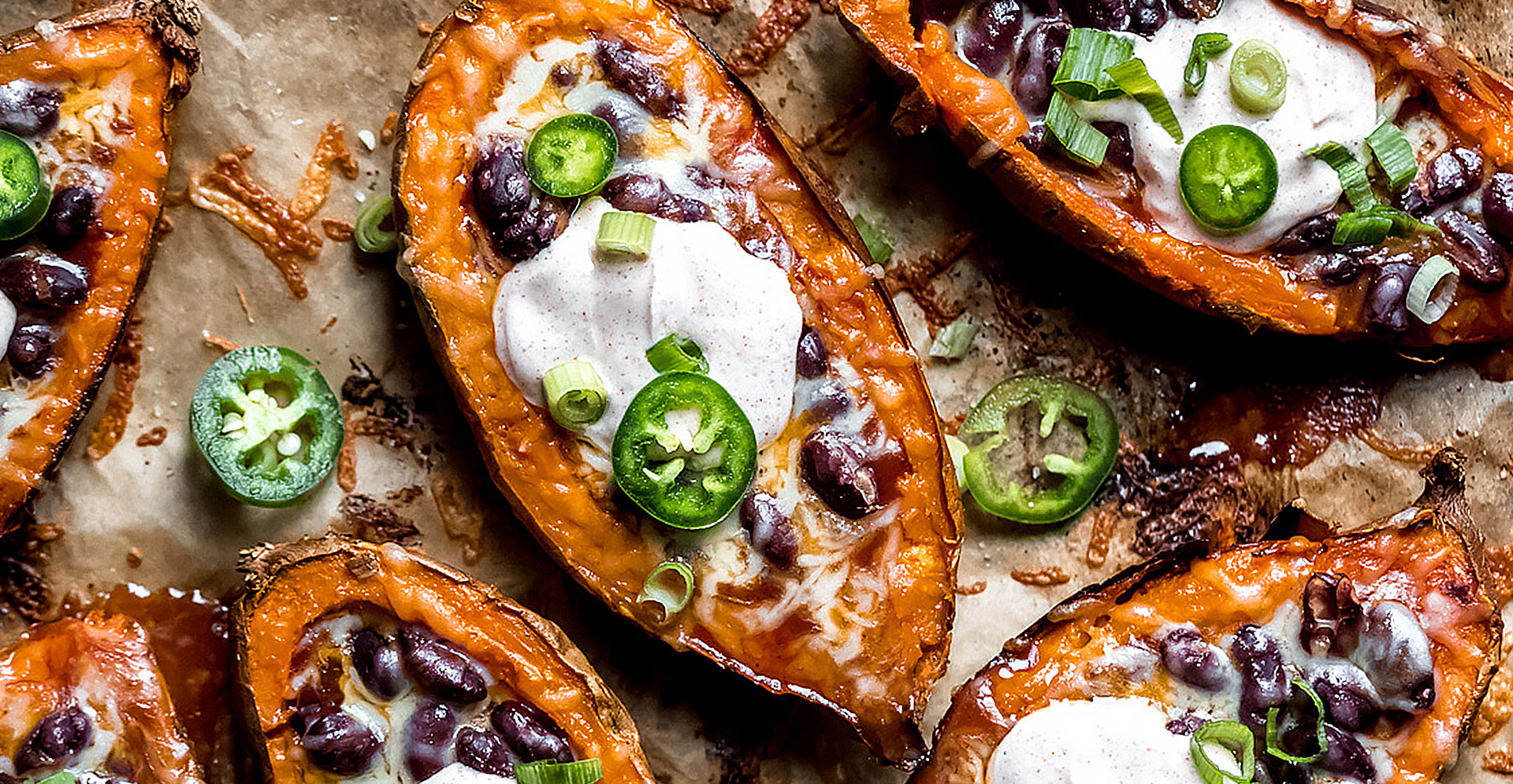 Baked stuff sweet potato skins with chili beans, cheese, green onions and jalapenos