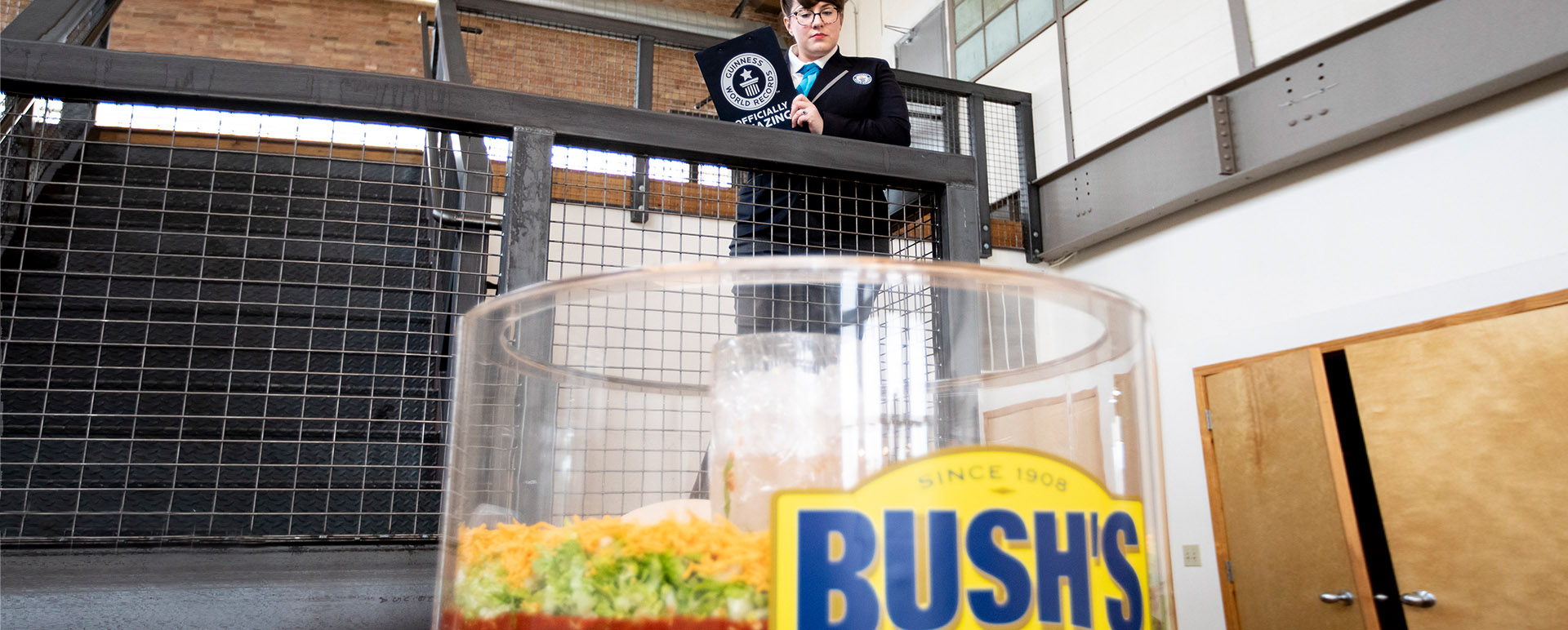 A person from Guinness Book of World Records inspecting a 70-layer bean dip