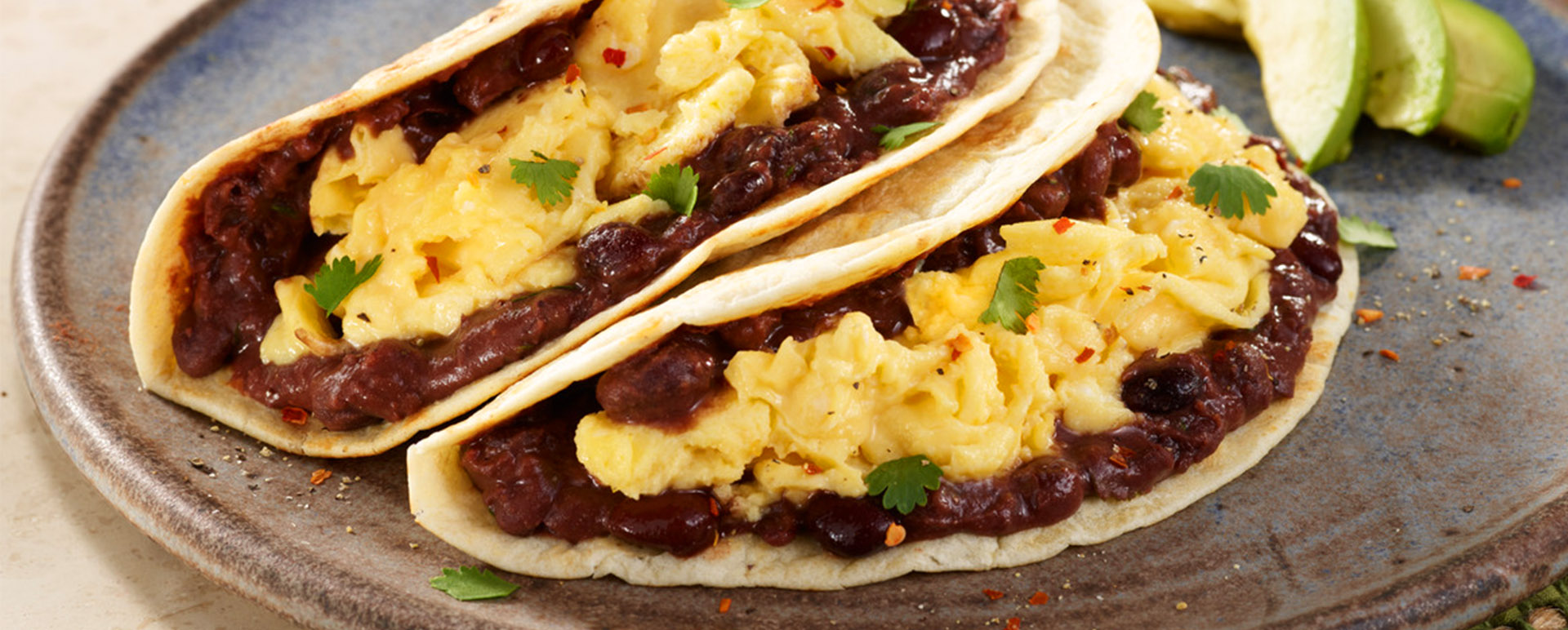 Bean and egg breakfast tacos on a plate