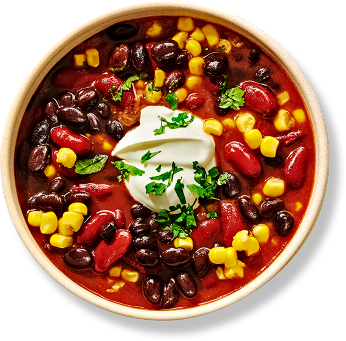 Bowl of chili with black beans, kidney beans, and corn topped with sour cream